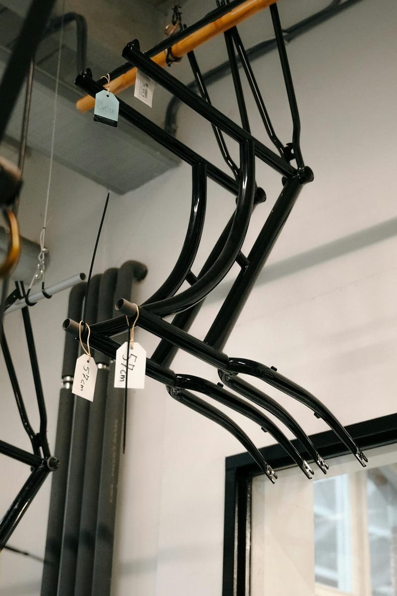 Steel bicycle frames hanging in a framebuilder workshop