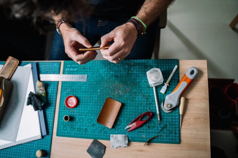 Leather workshop from above, cutting mat and tools
